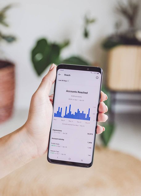 Mobile phone displaying website analytics and performance metrics